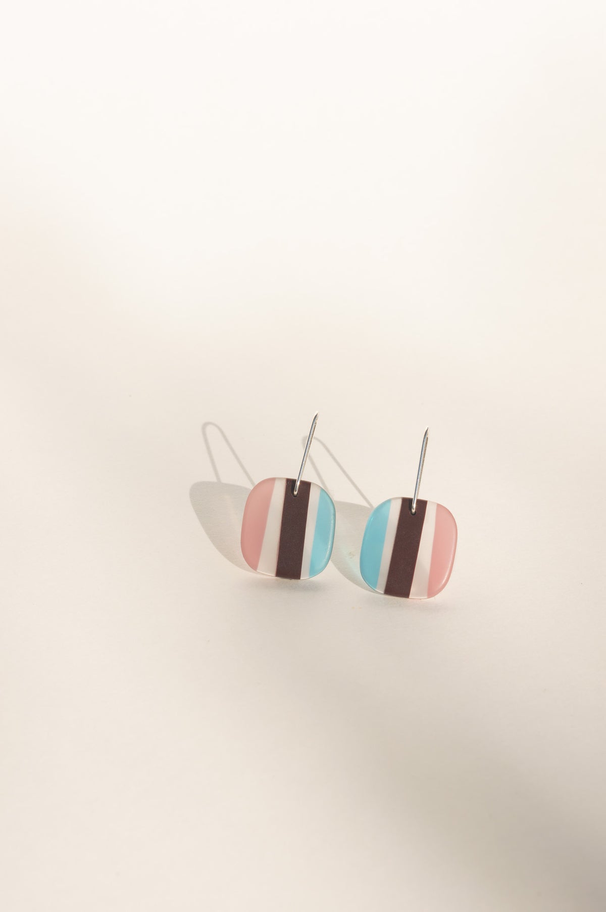 Daydream 2 medium earrings with blush pink and aqua halves split by a cocoa stripe, upcycled surfboard resin