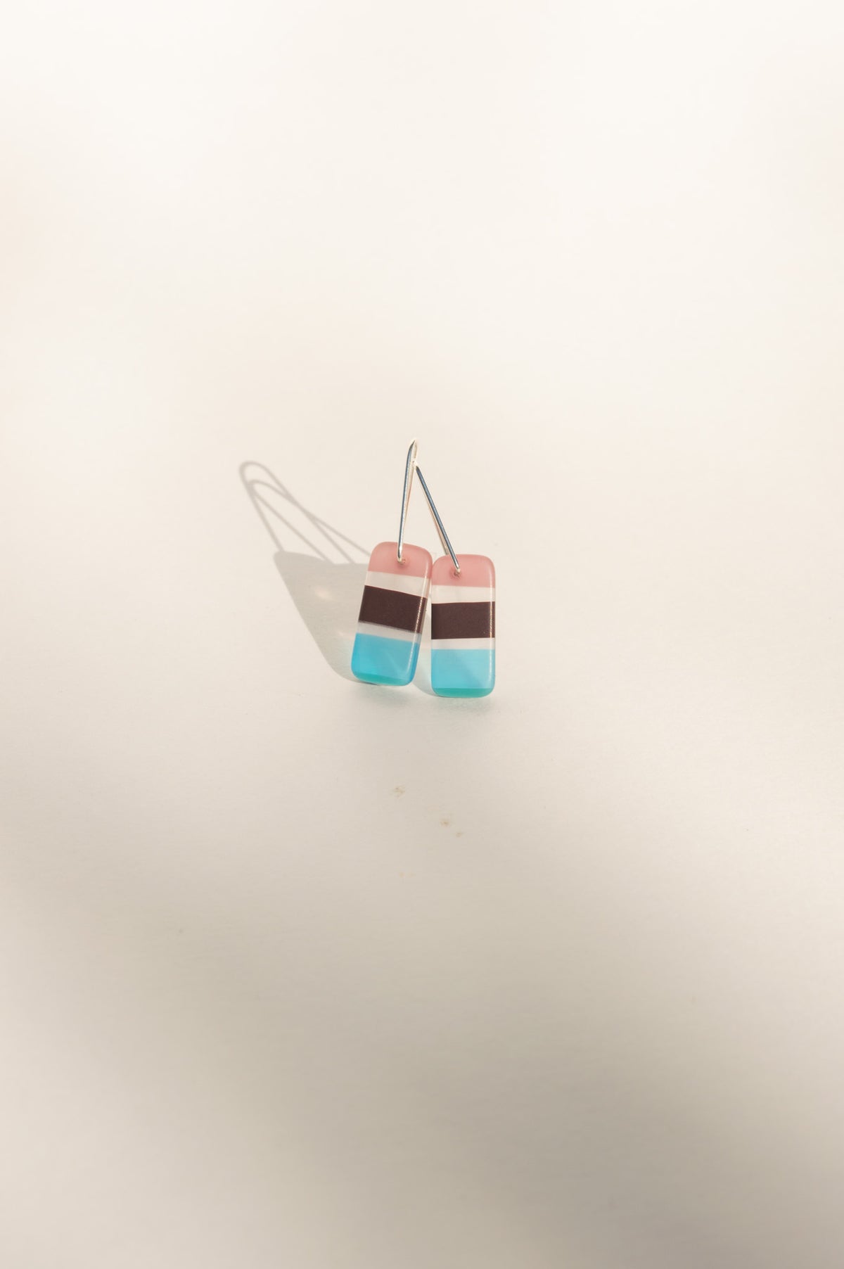 Daydream 3 small earrings with pink, cocoa, white and aqua stripes in upcycled surfboard resin
