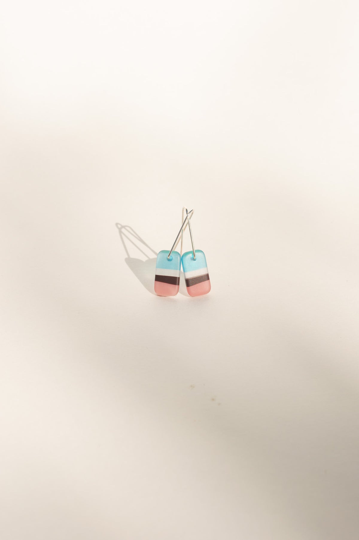 Daydream 7 extra small earrings with aqua, white, cocoa and pink stripes in upcycled surfboard resin